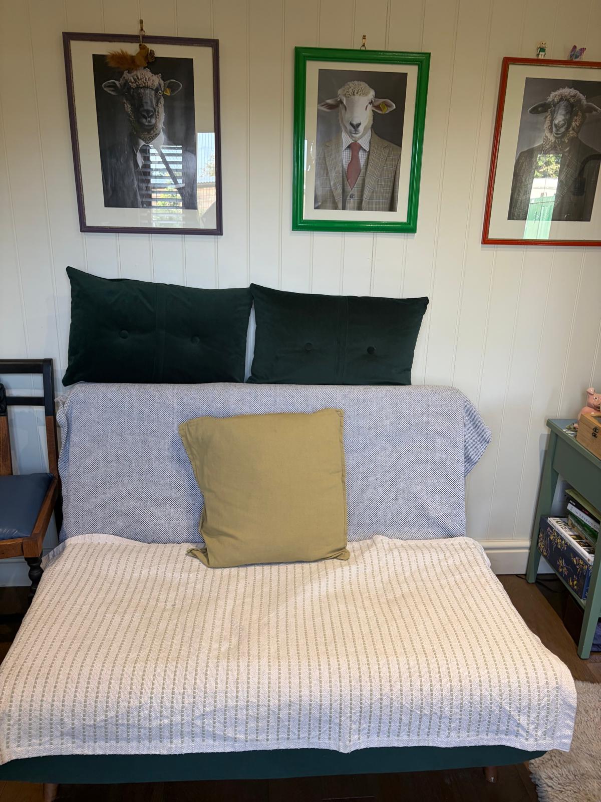 Sofa and sheep portraits in the large hut