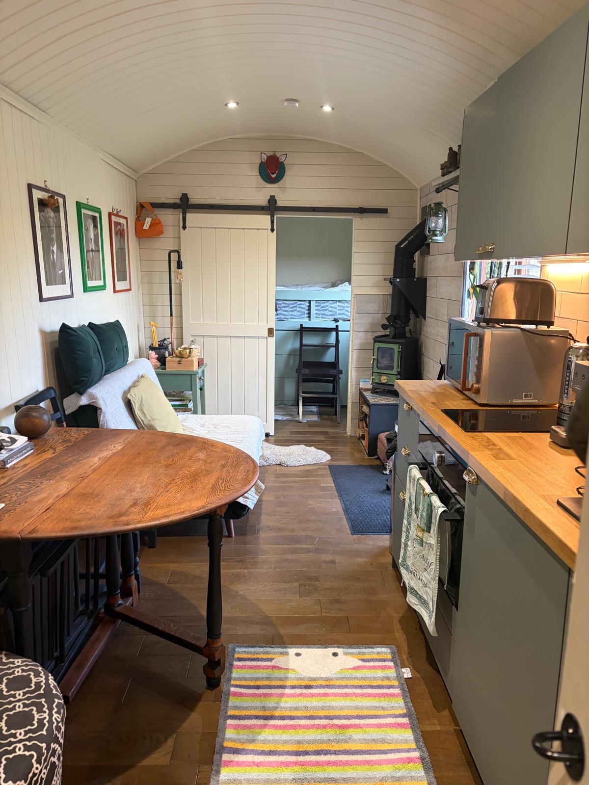 Kitchen, table and bunks in the large hut
