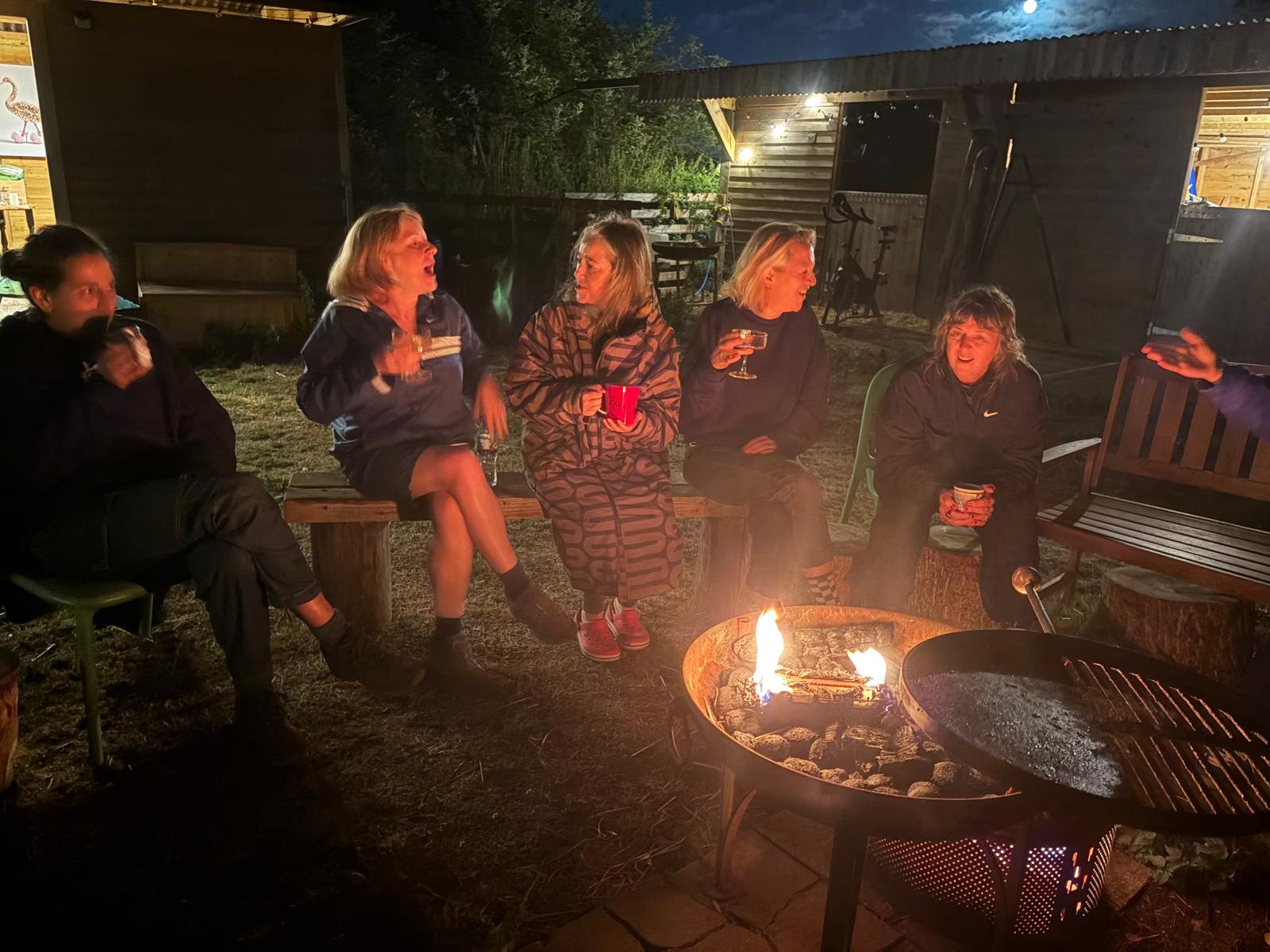 Guests sitting around the fire pit in the evening