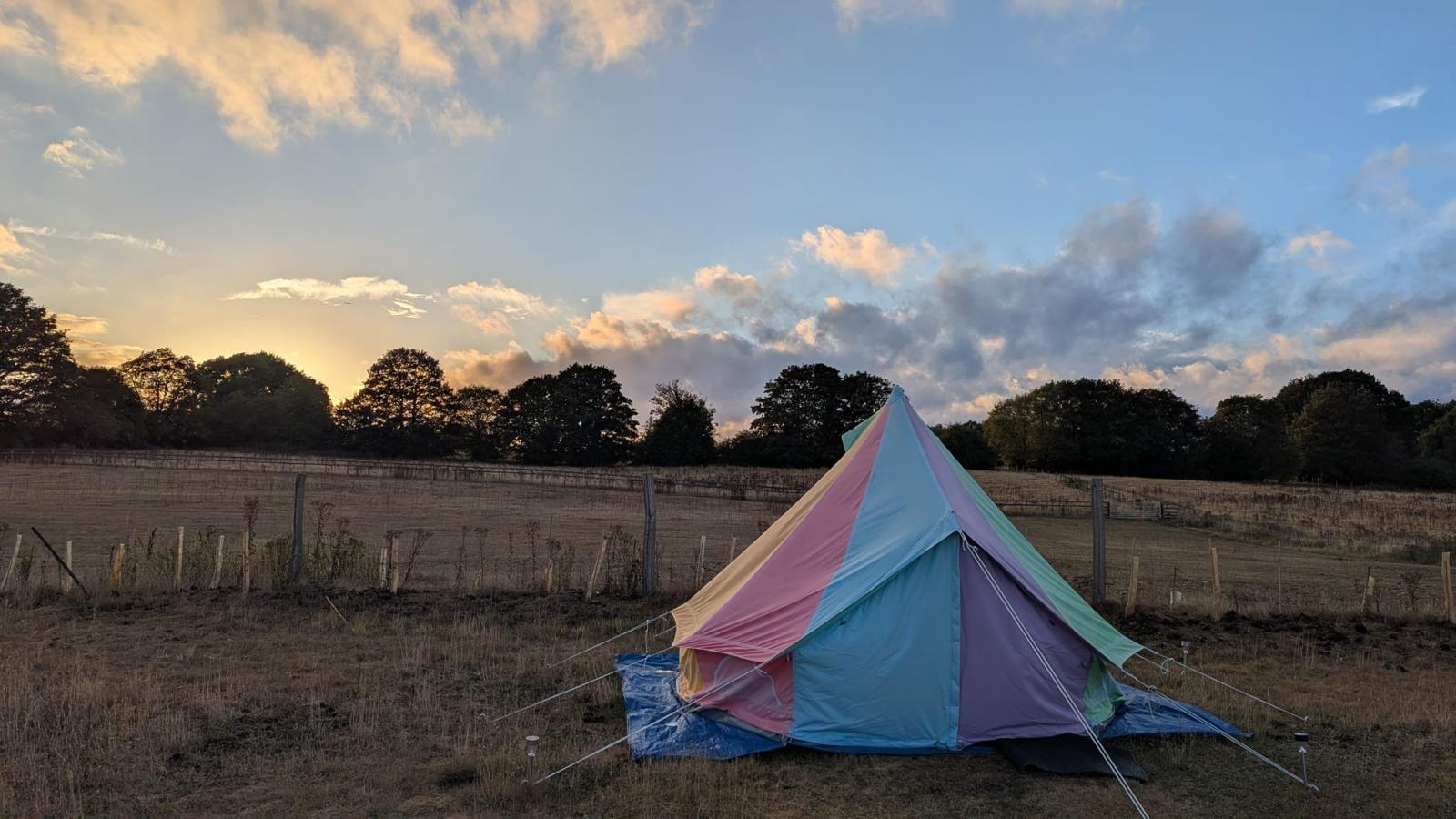 Bell tent on the field at sunset