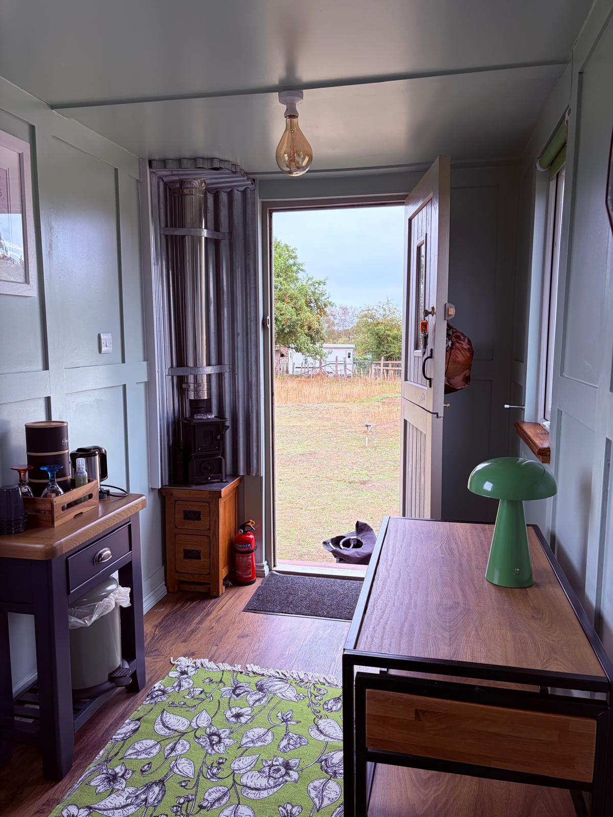 Small hut doorway and wood burner