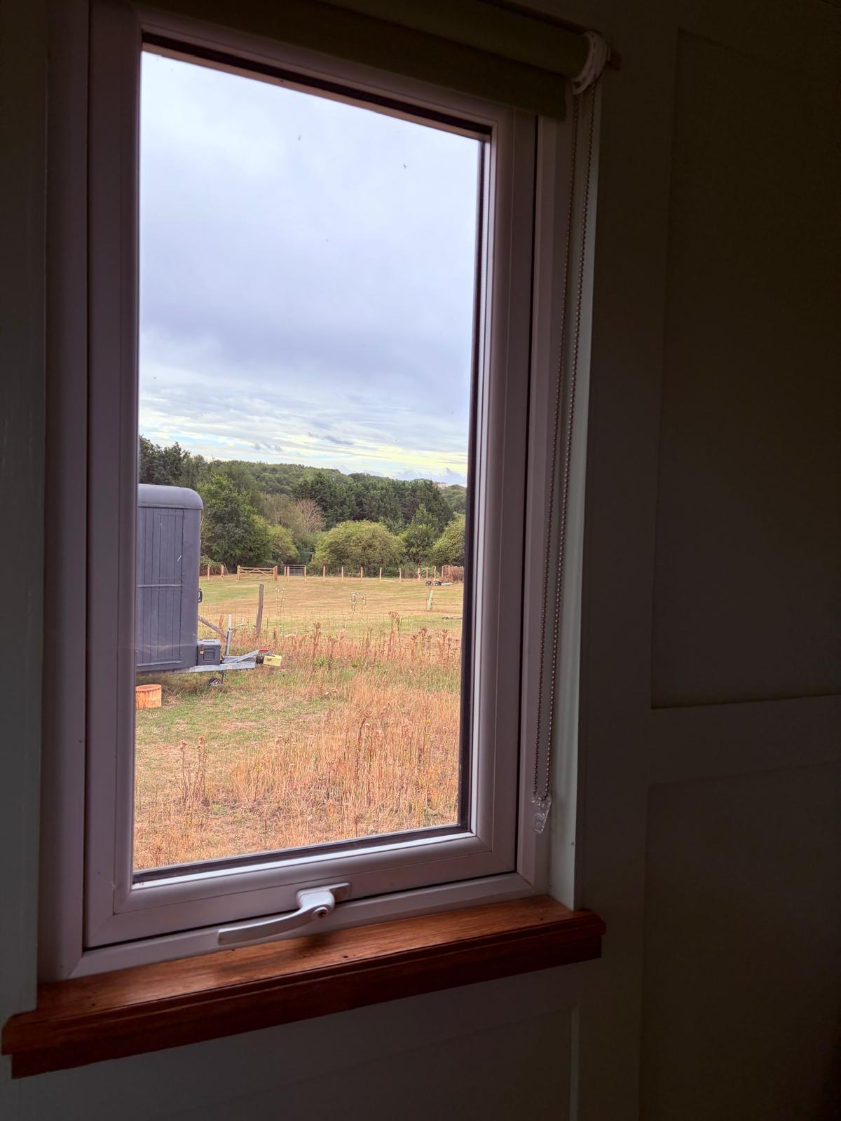 View from the small hut window across the field