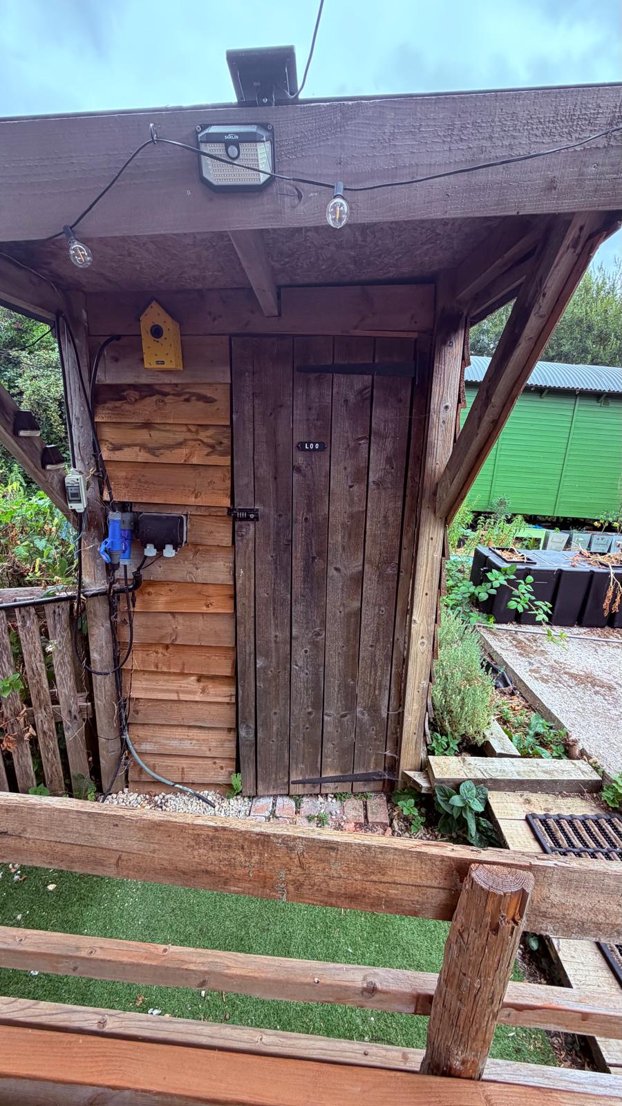 The wooden outdoor loo