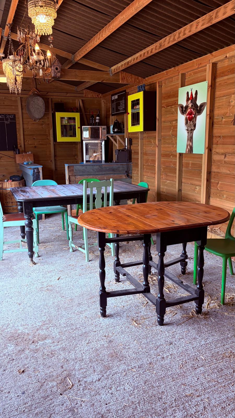 The barn with tables, chairs and a kitchen for tea and coffee